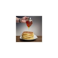 pancakes on a plate with syrup being poured onto them