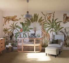 a baby's room decorated with jungle animals and giraffes