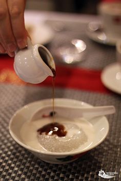 a person pours coffee into a small bowl