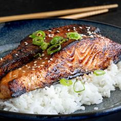 salmon and rice on a plate with chopsticks