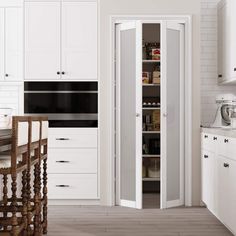 a kitchen with white cabinets and an open pantry in the center, along with a wooden dining table