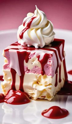 a piece of cake covered in red and white icing with a scoop of ice cream on top