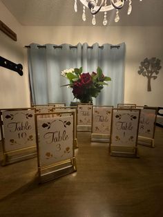 there are place cards on the table for guests to take their seats and have flowers in them