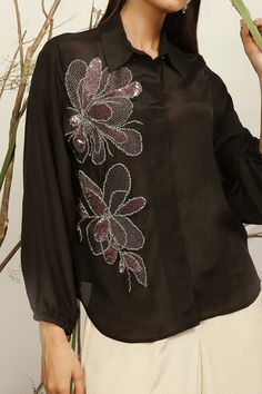 Black shirt with floral embroidered motifs, elasticated sleeves and sequin work.
Components:1
Embroidered
Neckline:Shirt Collar
Sleeve Length:Full
Fabric:Silk Crepe
Color:Black
Note: Pant worn by the model is not for sale - Aza Fashions Elegant Long Sleeve Sequin Shirt, Hand Embellished Long Sleeve Blouse, Black Embellished Shirt For Party, Embellished Long Sleeve Party Shirt, Elegant Silk Embroidered Top With Long Sleeves, Evening Floral Embroidered Long Sleeve Blouse, Elegant Long Sleeve Blouse With Sequins, Elegant Long Sleeve Silk Embroidered Top, Elegant Long Sleeve Sequined Blouse Piece