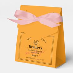 a yellow paper bag with pink ribbon tied around the front and side, on a white background