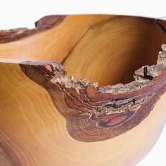 a wooden bowl that has been cut in half to look like it is being used as a vase