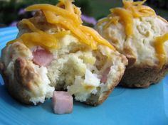 two muffins covered in cheese and ham on a blue plate