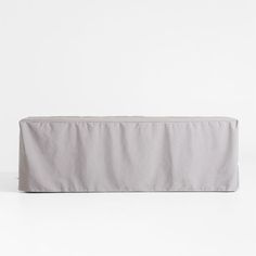 a white couch with a long cover on it