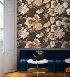 a living room with floral wallpaper and blue velvet couches