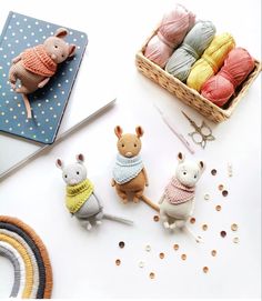 there are knitted mice and yarns on the table