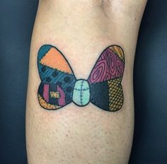 an artistic tattoo on the leg of a person's legs with different colored designs