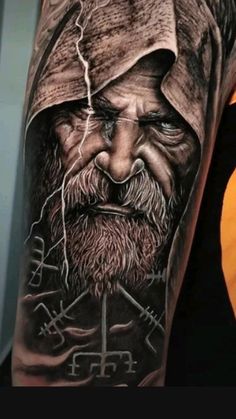 a man's arm with a tattoo on it that has an image of a bearded man