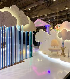 a room filled with furniture and clouds hanging from the ceiling