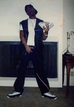 a man is standing in front of a fireplace