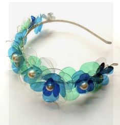 a headband with blue flowers and pearls