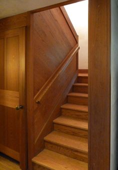 an open door leading to a wooden staircase