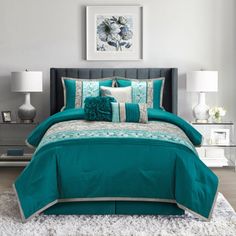 a bed with teal comforters and pillows in a bedroom