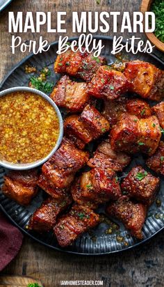 pork belly bites on a plate with dipping sauce and parsley next to the bowl