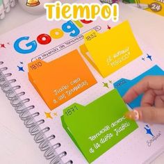 someone is writing on a notebook with different colored sticky notes in spanish and english, along with the words google