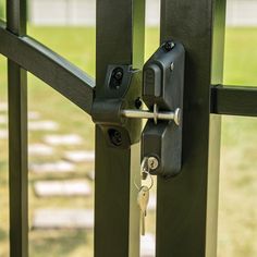 an open gate with two keys in it