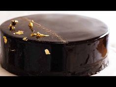 a chocolate cake with gold leaf decorations on top