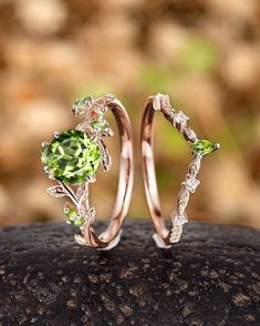 two wedding rings with green and white stones