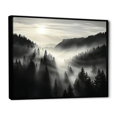 a black and white photo of fog in the mountains with trees on each side canvas wall art print