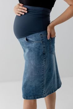 Bring the vintage look & feel of your favorite denim skirt into pregnancy! The 'Everlee' Maternity Denim Skirt has a full over-the-belly band for ultimate support and comfort for pregnancy and beyond. Versatile and on trend, wear this maternity denim skirt for work, the weekend, or wherever your day takes you. The medium wash provides endless styling options for your maternity wardrobe. Exclusively designed with you in mind! 97% Cotton, 3% Spandex Machine Wash Cold Gentle Cycle Do Not Bleach Tum Denim Maternity Wear Bottoms, Maternity Denim Bottoms Bump Friendly, Casual Maternity Denim Bottoms, Maternity Denim Bottoms In Medium Wash, Maternity Wear Medium Wash Denim Bottoms, Spring Maternity Denim Bottoms, Cotton Maternity Bottoms For Spring, Maternity Cotton Bottoms For Spring, Spring Maternity Cotton Bottoms