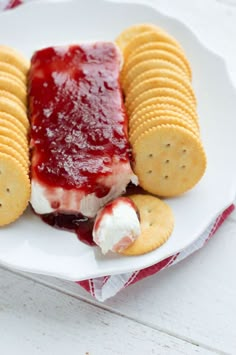 a white plate topped with crackers and jelly