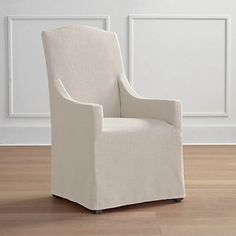 a white chair sitting on top of a hard wood floor