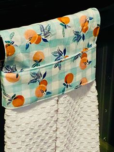 an orange print towel hanging on a rack