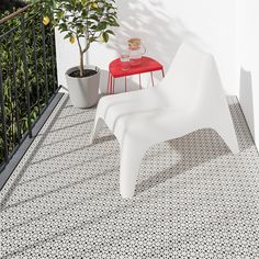 two white chairs sitting on top of a balcony next to a red table and potted plant