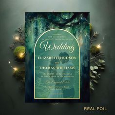 the wedding card is surrounded by greenery and lights