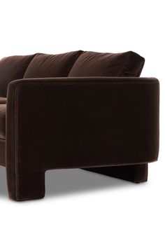 a brown couch sitting on top of a white floor