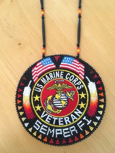 a beaded necklace with the marine corp logo on it