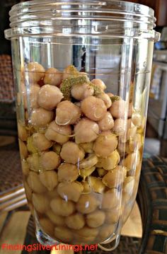 a glass jar filled with nuts sitting on top of a table