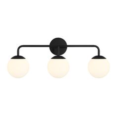 three lights on a wall mounted fixture with black metal frame and white glass globes