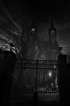 a black and white photo of an old building at night