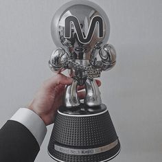 a person holding up a trophy in their hand