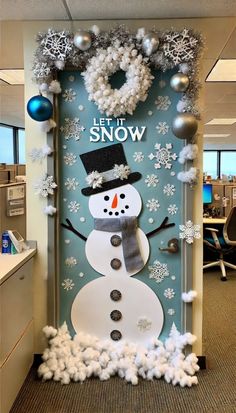 an office cubicle decorated with snowmen and wreaths for the door to decorate