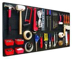 a black pegboard with various tools and other items hanging on it's side