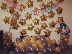 balloons and confetti are arranged in the shape of stars on a party table