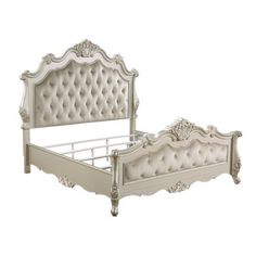 a white bed with an ornate headboard and foot board is shown against a white background