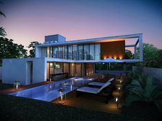 a modern house with an outdoor pool and lounge area at night time in the evening