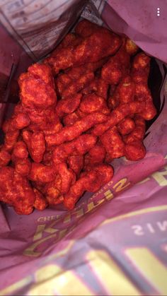 a bag filled with red food sitting on top of a table