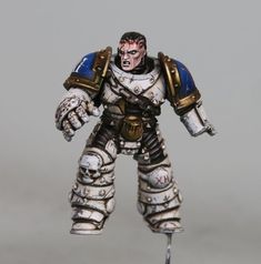 a white and blue painted warhammer with two hands