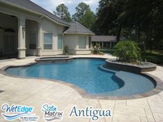 a large swimming pool with steps leading up to it and a patio area in the background