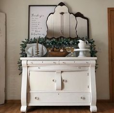 a white dresser with christmas decorations on top