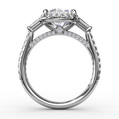 a white gold engagement ring with an oval diamond center