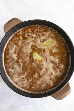 a pan filled with food sitting on top of a table